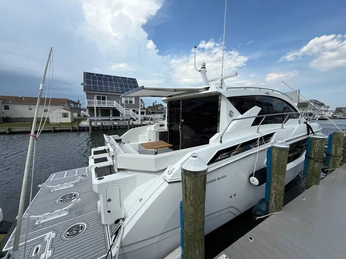  Yacht Photos Pics 2018 Cruisers Yachts 42 Cantius docked at marina under blue sky.