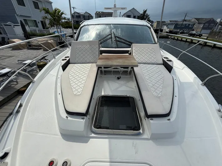  Yacht Photos Pics 2018 Cruisers Yachts 42 Cantius with sunbathing area and table on deck.