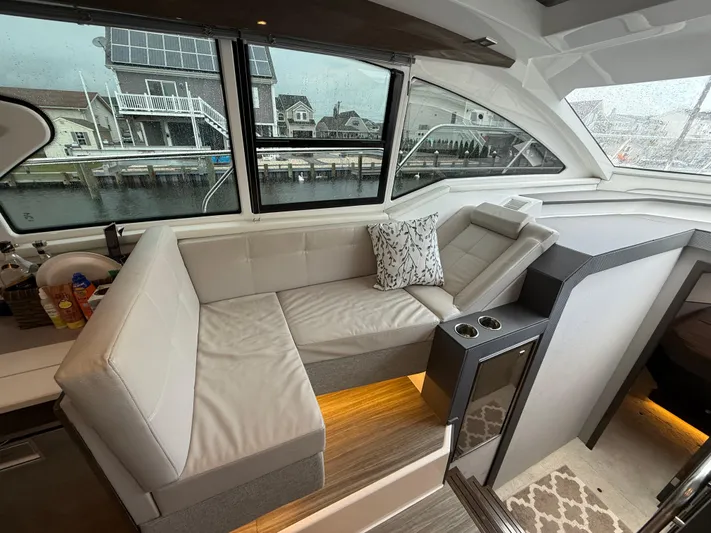  Yacht Photos Pics Luxurious interior of 2018 Cruisers Yachts 42 Cantius with plush seating and waterfront view.