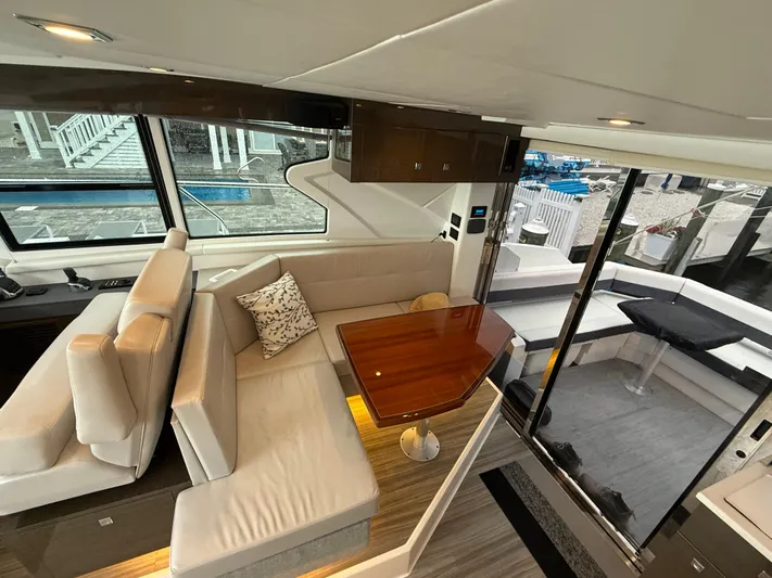 Yacht Photos Pics Interior of 2018 Cruisers Yachts 42 Cantius with elegant seating and wooden table.