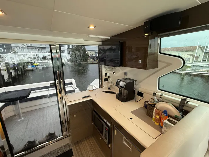  Yacht Photos Pics Interior of 2018 Cruisers Yachts 42 Cantius with modern kitchen and marina view.