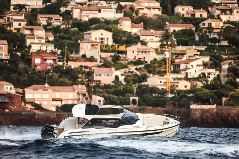  Yacht Photos Pics 2024 Skamander Sorrento boat cruising near coastal homes.