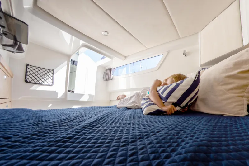  Yacht Photos Pics 2024 Skamander Sorrento cabin interior with cozy bed and natural light.