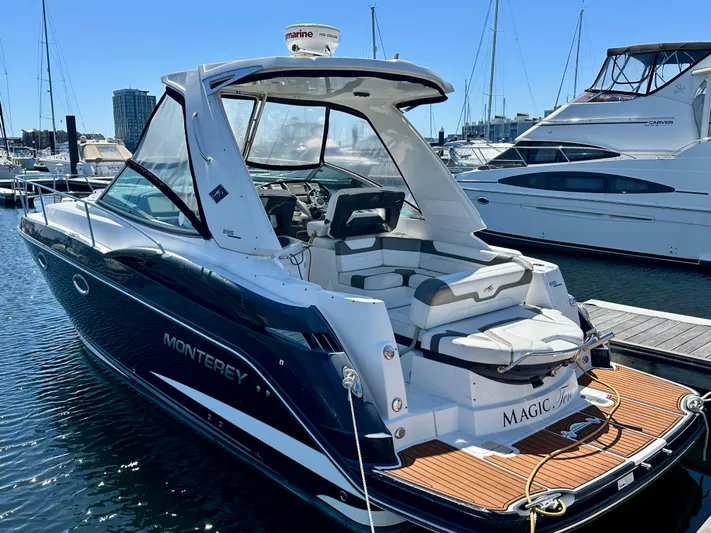 Magic Ten Yacht Photos Pics 2015 Monterey 335 Sport Yacht docked at marina, showcasing sleek design and spacious deck.