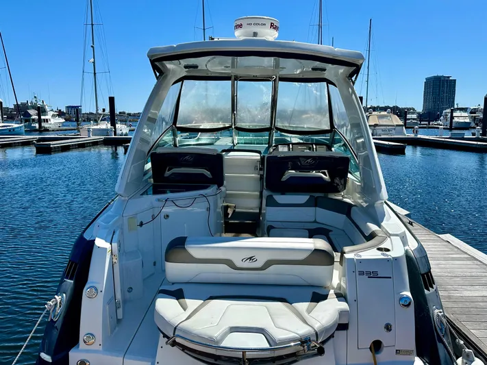 Magic Ten Yacht Photos Pics 2015 Monterey 335 Sport Yacht docked at marina, showcasing spacious seating and sleek design.