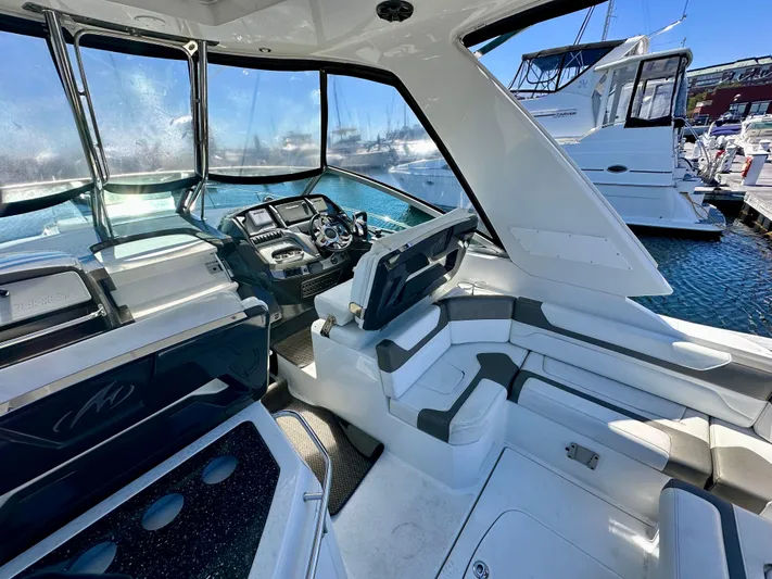 Magic Ten Yacht Photos Pics 2015 Monterey 335 Sport Yacht interior with helm, seating, and marina view.
