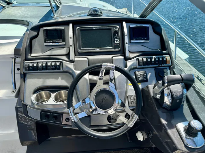Magic Ten Yacht Photos Pics Cockpit of 2015 Monterey 335 Sport Yacht with steering wheel and navigation controls.