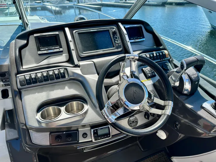 Magic Ten Yacht Photos Pics Cockpit of 2015 Monterey 335 Sport Yacht with modern controls and steering wheel.