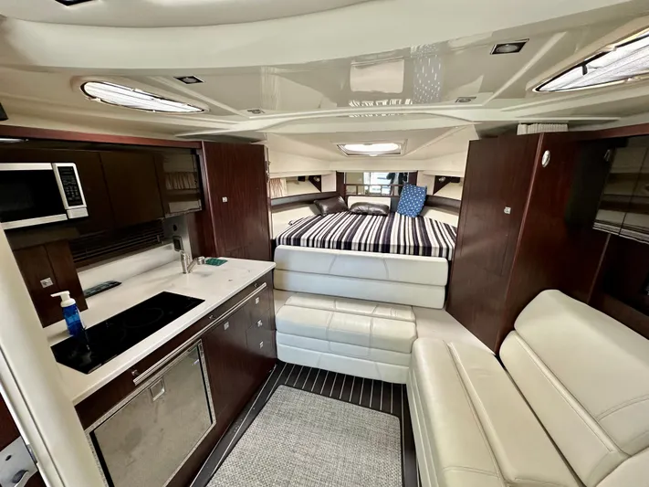 Magic Ten Yacht Photos Pics Interior of 2015 Monterey 335 Sport Yacht with modern kitchen and cozy seating.