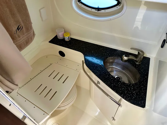 Magic Ten Yacht Photos Pics 2015 Monterey 335 Sport Yacht bathroom with sink, porthole, and towel.