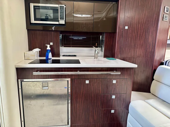 Magic Ten Yacht Photos Pics Compact kitchen in 2015 Monterey 335 Sport Yacht with microwave and sink.