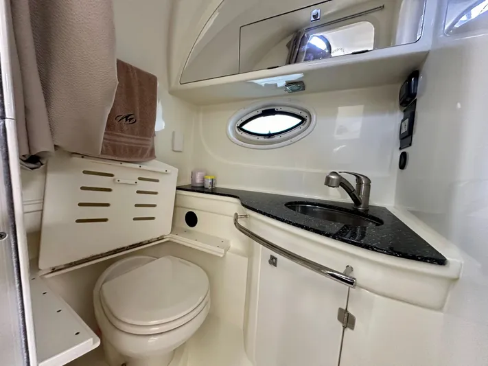 Magic Ten Yacht Photos Pics 2015 Monterey 335 Sport Yacht bathroom with sink, toilet, and storage.