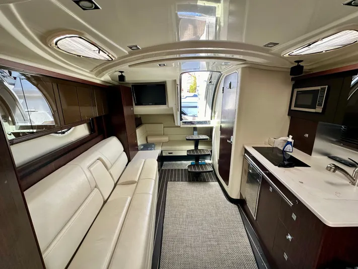 Magic Ten Yacht Photos Pics Interior of 2015 Monterey 335 Sport Yacht with modern kitchen and seating area.