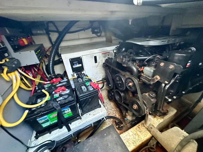 Magic Ten Yacht Photos Pics Engine room of a 2015 Monterey 335 Sport Yacht with visible batteries and wiring.