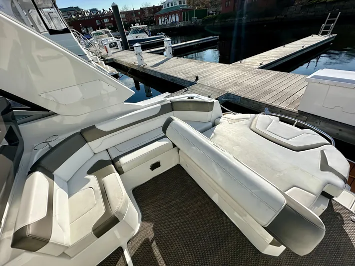 Magic Ten Yacht Photos Pics 2015 Monterey 335 Sport Yacht interior with seating, dockside view.