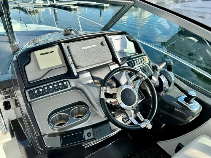 Magic Ten Yacht Photos Pics Helm of 2015 Monterey 335 Sport Yacht with modern controls and steering wheel.