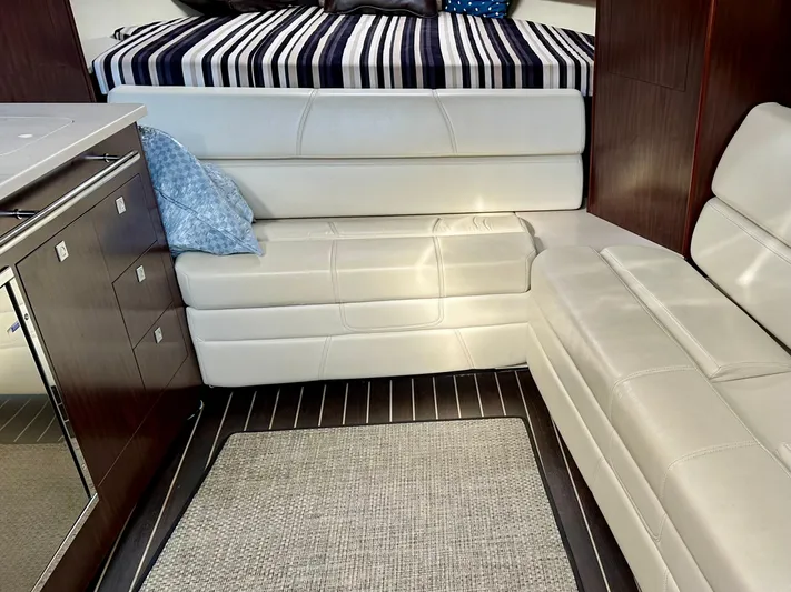 Magic Ten Yacht Photos Pics Interior of 2015 Monterey 335 Sport Yacht with leather seating and striped bedding.