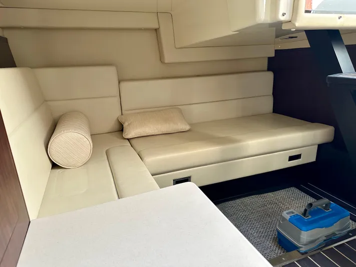 Magic Ten Yacht Photos Pics 2015 Monterey 335 Sport Yacht interior with beige seating and cushions.