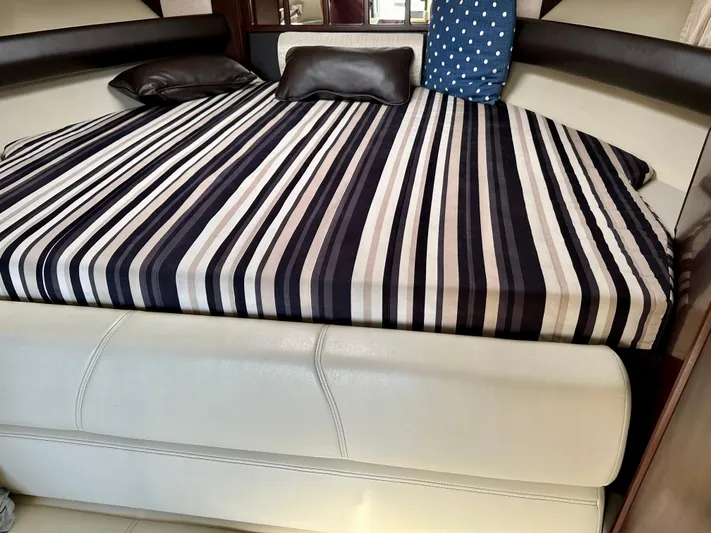 Magic Ten Yacht Photos Pics Interior of 2015 Monterey 335 Sport Yacht with striped bedding and cushions.