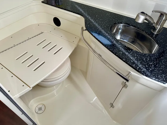 Magic Ten Yacht Photos Pics 2015 Monterey 335 Sport Yacht bathroom with sink and covered toilet.