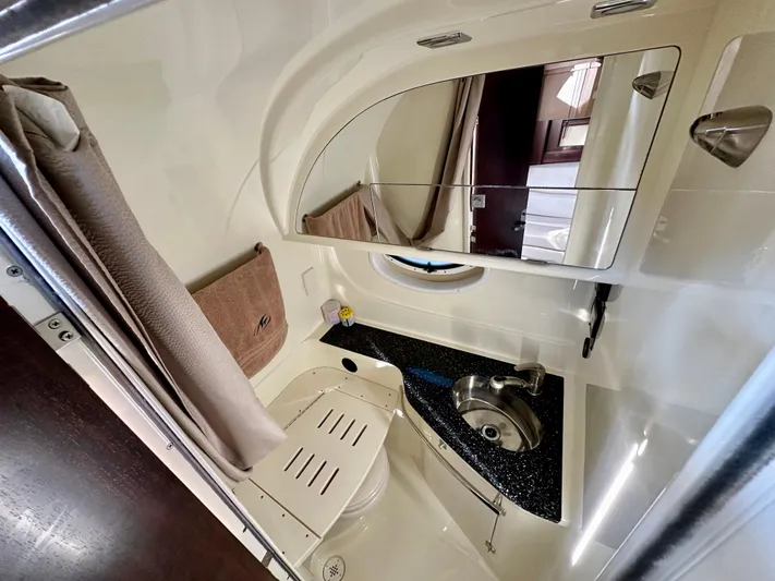 Magic Ten Yacht Photos Pics 2015 Monterey 335 Sport Yacht bathroom with sink, mirror, and towel.