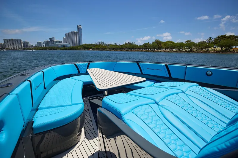  Yacht Photos Pics Luxurious 2022 Midnight Express 43' Solstice boat with blue seating, city skyline view.