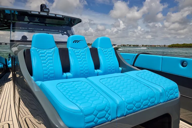  Yacht Photos Pics 2022 Midnight Express 43' Solstice boat with vibrant blue seating on a sunny day.