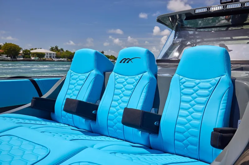  Yacht Photos Pics 2022 Midnight Express 43' Solstice boat with vibrant blue seating on a sunny day.