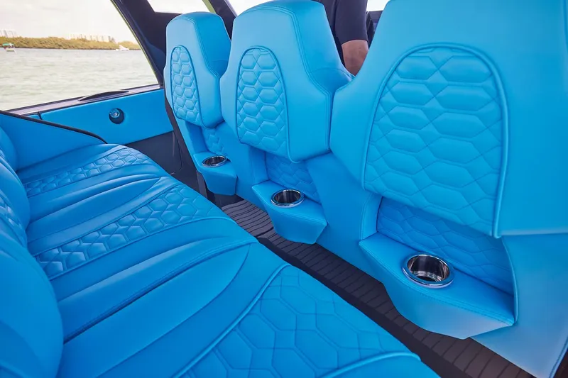  Yacht Photos Pics Luxurious blue seating on 2022 Midnight Express 43' Solstice boat, featuring cup holders and quilted design.