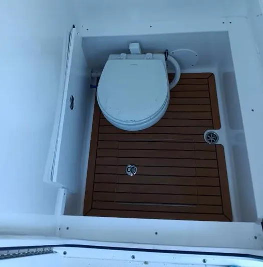  Yacht Photos Pics 2018 Buddy Davis 28 Center Console boat toilet with wooden flooring.
