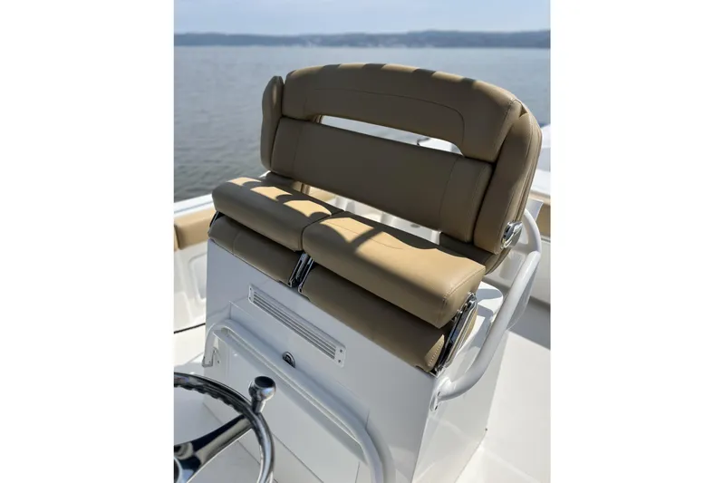  Yacht Photos Pics 2018 Buddy Davis 28 Center Console boat seat with tan upholstery, overlooking calm waters.