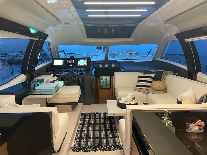  Yacht Photos Pics Luxurious interior of 2016 Ferretti Yachts 550 with modern seating and navigation area.