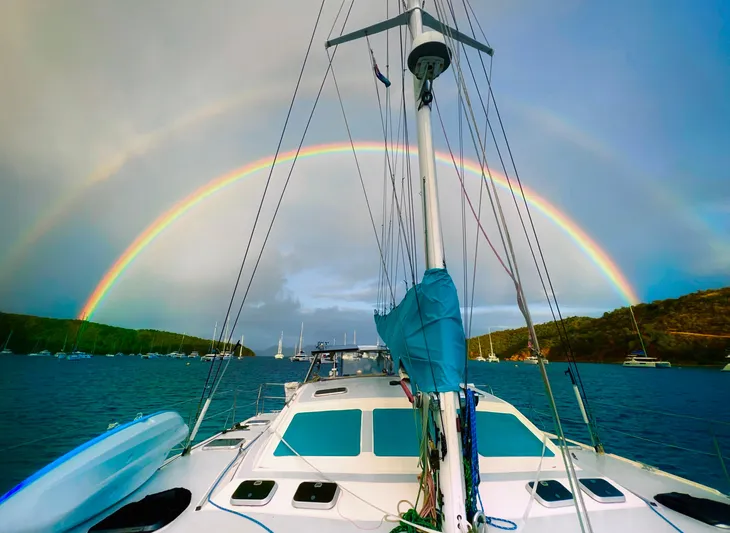 Majestic Yacht Photos Pics Sailing yacht St Francis 44 MKII under vibrant rainbow in scenic harbor.