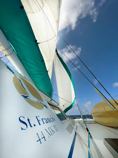 Majestic Yacht Photos Pics Sailing yacht St Francis 44 MKII, 1999 model, with green sails against a blue sky.
