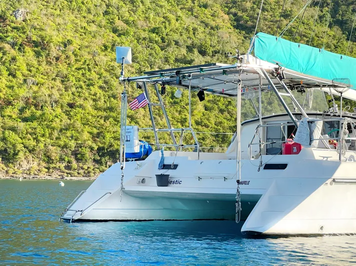 Majestic Yacht Photos Pics 1999 St Francis 44 MKII catamaran anchored in scenic bay with lush green hills.