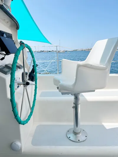 Majestic Yacht Photos Pics Sailboat cockpit with white chair and turquoise-wrapped wheel, St Francis 44 MKII, 1999.