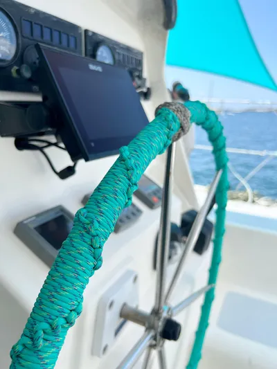 Majestic Yacht Photos Pics Close-up of St Francis 44 MKII yacht helm with turquoise-wrapped wheel, 1999 model.