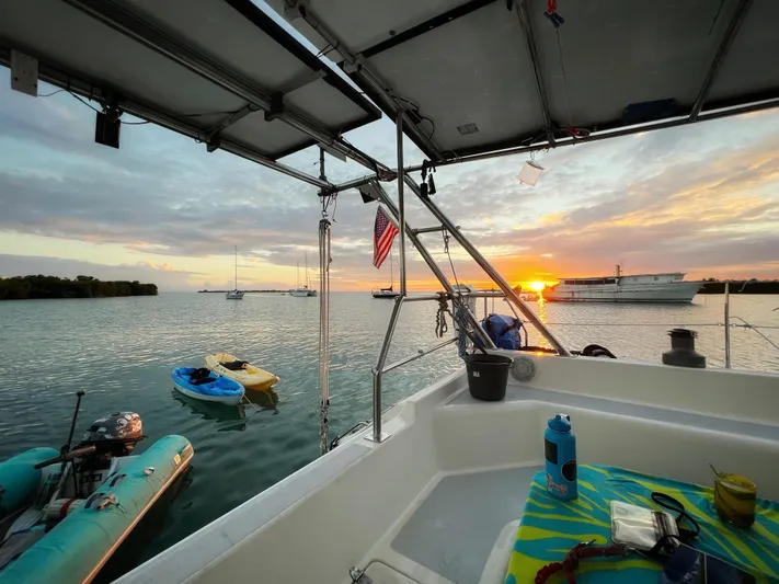 Majestic Yacht Photos Pics Sunset view from 1999 St Francis 44 MKII sailboat, with kayaks and boats in the water.