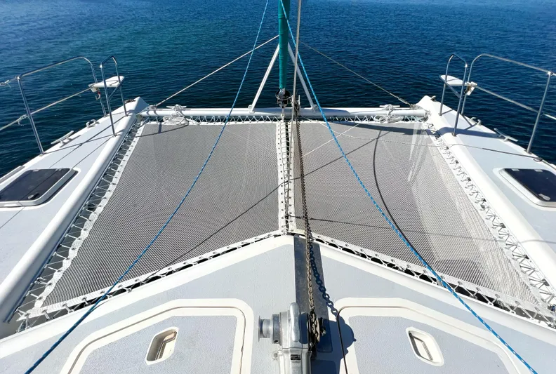 Majestic Yacht Photos Pics Catamaran deck with netting, St Francis 44 MKII, 1999, sailing on calm blue waters.