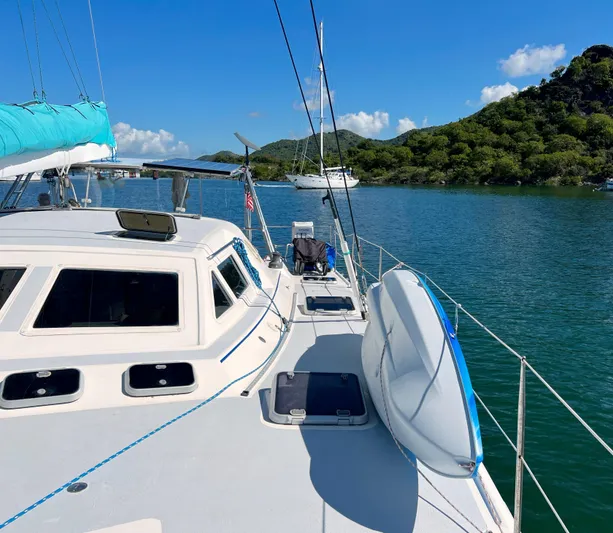 Majestic Yacht Photos Pics Sailing yacht St Francis 44 MKII, 1999, anchored in scenic bay with lush hills.