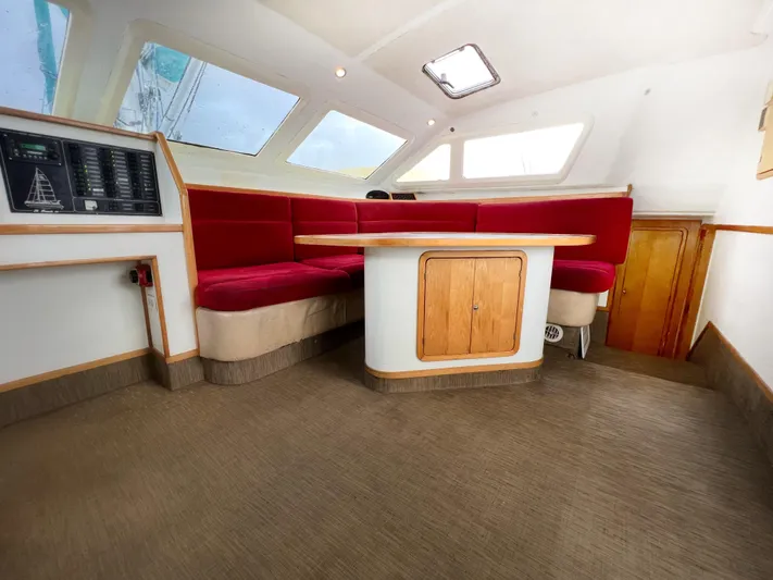 Majestic Yacht Photos Pics Spacious interior of 1999 St Francis 44 MKII yacht with red seating and wooden accents.