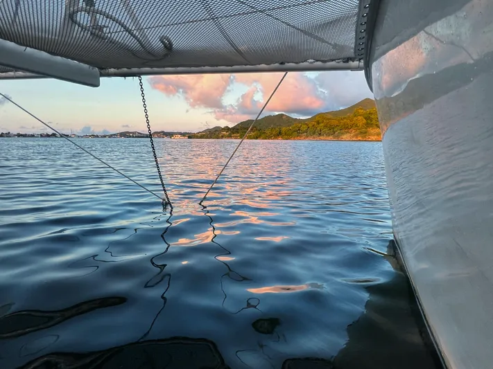 Majestic Yacht Photos Pics Sailing on a 1999 St Francis 44 MKII catamaran at sunset, calm waters, scenic view.