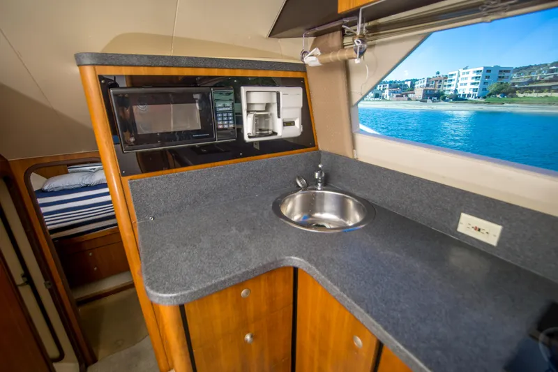 Lost Boys Yacht Photos Pics 2002 Luhrs 36 Convertible yacht interior with kitchenette, sink, and ocean view.