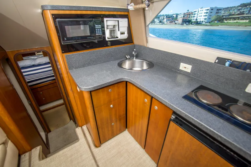 Lost Boys Yacht Photos Pics 2002 Luhrs 36 Convertible yacht kitchen with modern appliances and ocean view.