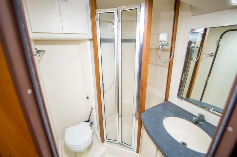 Lost Boys Yacht Photos Pics Bathroom interior of 2002 Luhrs 36 Convertible yacht with shower and sink.