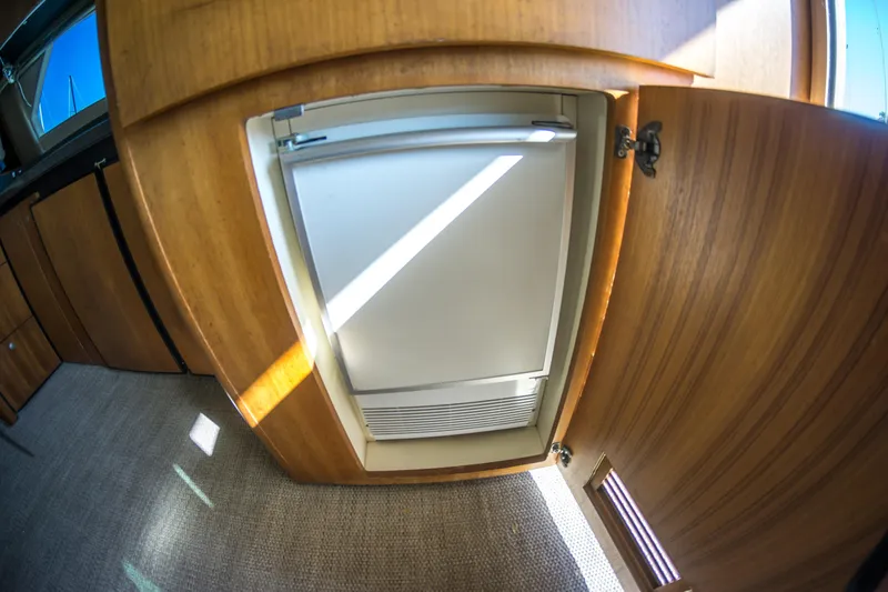 Lost Boys Yacht Photos Pics Wooden interior of 2002 Luhrs 36 Convertible yacht with built-in refrigerator.