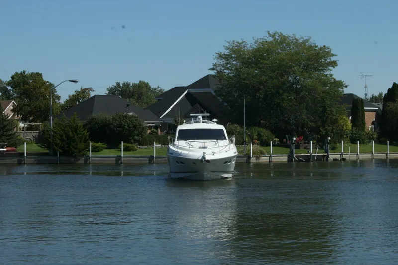  Yacht Photos Pics 2014 Sea Ray 510 Sundancer yacht docked near residential area with trees and houses.