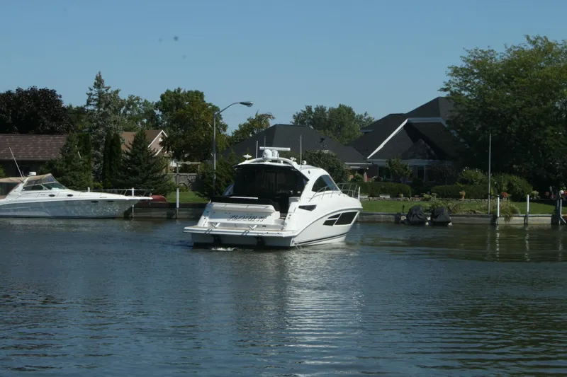  Yacht Photos Pics 2014 Sea Ray 510 Sundancer yacht cruising on a calm residential waterway.