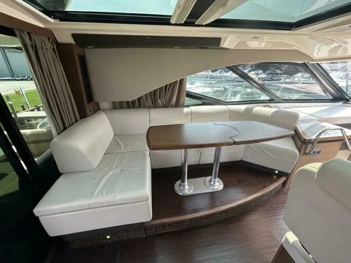 Yacht Photos Pics Luxurious interior of 2014 Sea Ray 510 Sundancer yacht with elegant seating and table.