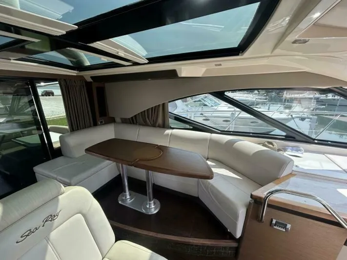  Yacht Photos Pics Luxurious interior of 2014 Sea Ray 510 Sundancer yacht with elegant seating and panoramic windows.